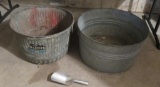 Two galvanized bushel baskets and scoop