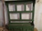 Green painted wall shelf with drawers