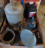Automotive lot with metal gas and oil cans and funnel