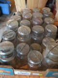 About 23 clear jars, bail closure, glass tops, pints, 1/2 pints and quarts