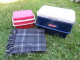 Tailgate lot, two coolers and picnic blanket