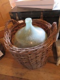 Huge glass bottle in basket