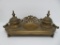 Ornate double metal inkwell with pen tip tray