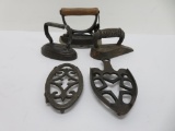 Three very interesting miniature flat irons and two trivets