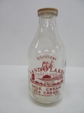 Half Gallon Land O Lakes Oconomowoc Milk bottle with red ACL pyro decorated with cow and children