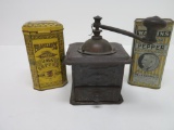 Metal vintage coffee grinder and two metal tins, coffee and pepper