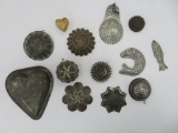 Thirteen metal molds, fluted and ornate shapes