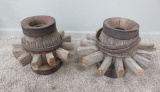 Two wooden wagon wheel hubs with partial spokes