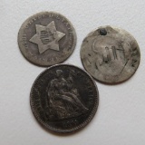 Three US silver coins, three cent and dime