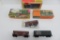 Six assorted HO train cars, two with boxes