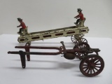 Two cast iron Fire Department horse drawn trucks, ladder and bell, c. early 1900's