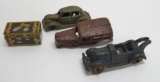 Three cast iron car and truck chasis and tin travel steamer trunk