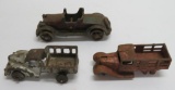 Three cast iron vehicles, c 1920's, two trucks and sedan