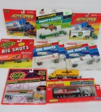 Nine die cast semi trucks and trailers, 8 on blister packs, HO scale