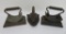 Three vintage cast iron sad irons, two are fluting irons with trivets