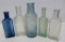 Five extract bottles, blue, green and clear, 4 1/2