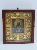 Ornate framed and period cased Russian icon, metal overlay