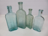 Four aqua medicine bottles, 5 1/2