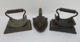 Three vintage cast iron sad irons, two are fluting irons with trivets