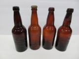 Four Schlitz, Pabst and Blatz amber beer bottles, heavily embossed
