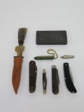 Six vintage pocket knives and honing stone