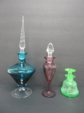 Three vintage colored perfume bottles,