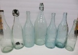 Seven large Wisconsin Beer and Soda bottles, clear and aqua, 9 1/2