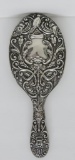Ornate hand mirror, faces-birds and floral