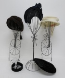 Five vintage hats and three metal hat stands