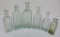 six medicine bottles, aqua and green, 5 1/2