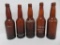 Five Wisconsin brewery amber bottles, crown top