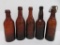 Five amber Milwaukee beer bottles, applied lip and blob top