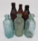 Six John Graf bottles, blue, green and amber