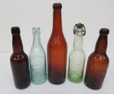 Five colored Milwaukee area brewery bottles