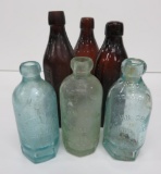 Six John Graf bottles, blue, green and amber