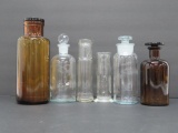 Amber and clear bottles with stoppers, Apothocary bottles