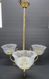 Brass ceiling light fixture with three etched glass shades, ornate