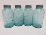 Four half gallon blue canning jars with zinc lids, 9