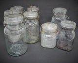 Eight clear canning jars with bail closures, quarts and pints