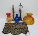 Table lamp bases, colored and ornate glass shades, and tapestry
