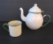Cream and green enamel teapot and cup, 7