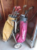 Two sets of vintage golf clubs with bags and one rolling cart