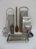 Vintage metal kitchen items, graters, juicer, and press