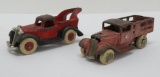 Two antique cast iron trucks, stake bed delivery and tow truck, 4
