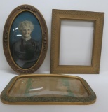 Three picture frames, one with portrait