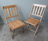 Two wooden slat folding chairs