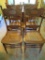 Four oak pressback chairs with cane seat