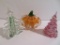 Three glass paperweights, pumpkin and two Christmas trees, 5