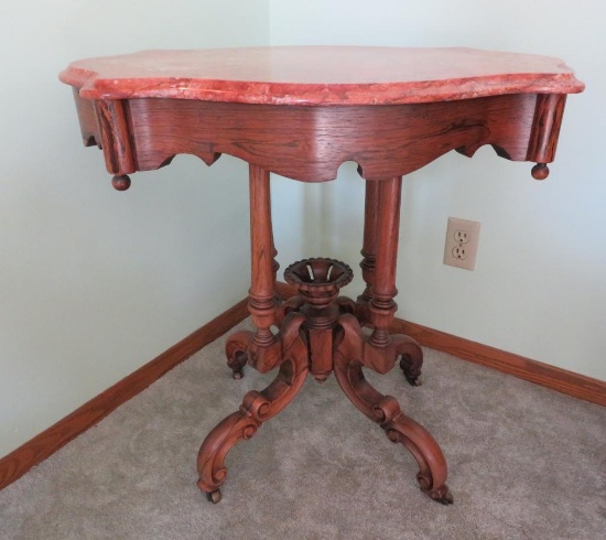 Unusual marble top table with salmon colored marble, walnut