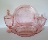 Four pieces of pink depression glass